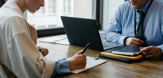 Two People Working At a Table